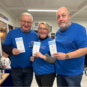 Blue Elephant team show leaflets promoting B-Herd App