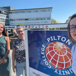 Blue Elephant team stand by the Pilton Community College sign