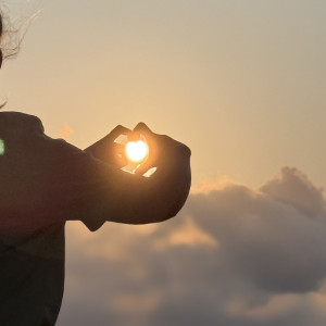 hands make heart over sun in sunset in Devon to support Blue Elephant Childcare blog called Summer Nights